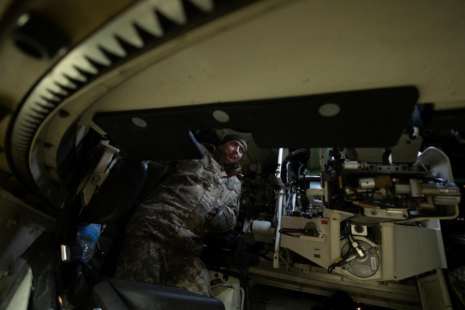 Andriy, a member of a Panzerhaubitze 2000 artillery unit climbs into a self-propelled howitzer on the second anniversary of Russia's invasion of Ukraine, in Donetsk region, Ukraine, February 24, 2024. Andriy has been fighting since day one of the war. "I think about home - my family, my child," he says in an interview. "But we are used to it, everything is routine. You work during the day and work during the night. When there is work, we work. We don't even think about it anymore." REUTERS/Thomas Peter Photo: Thomas Peter/REUTERS