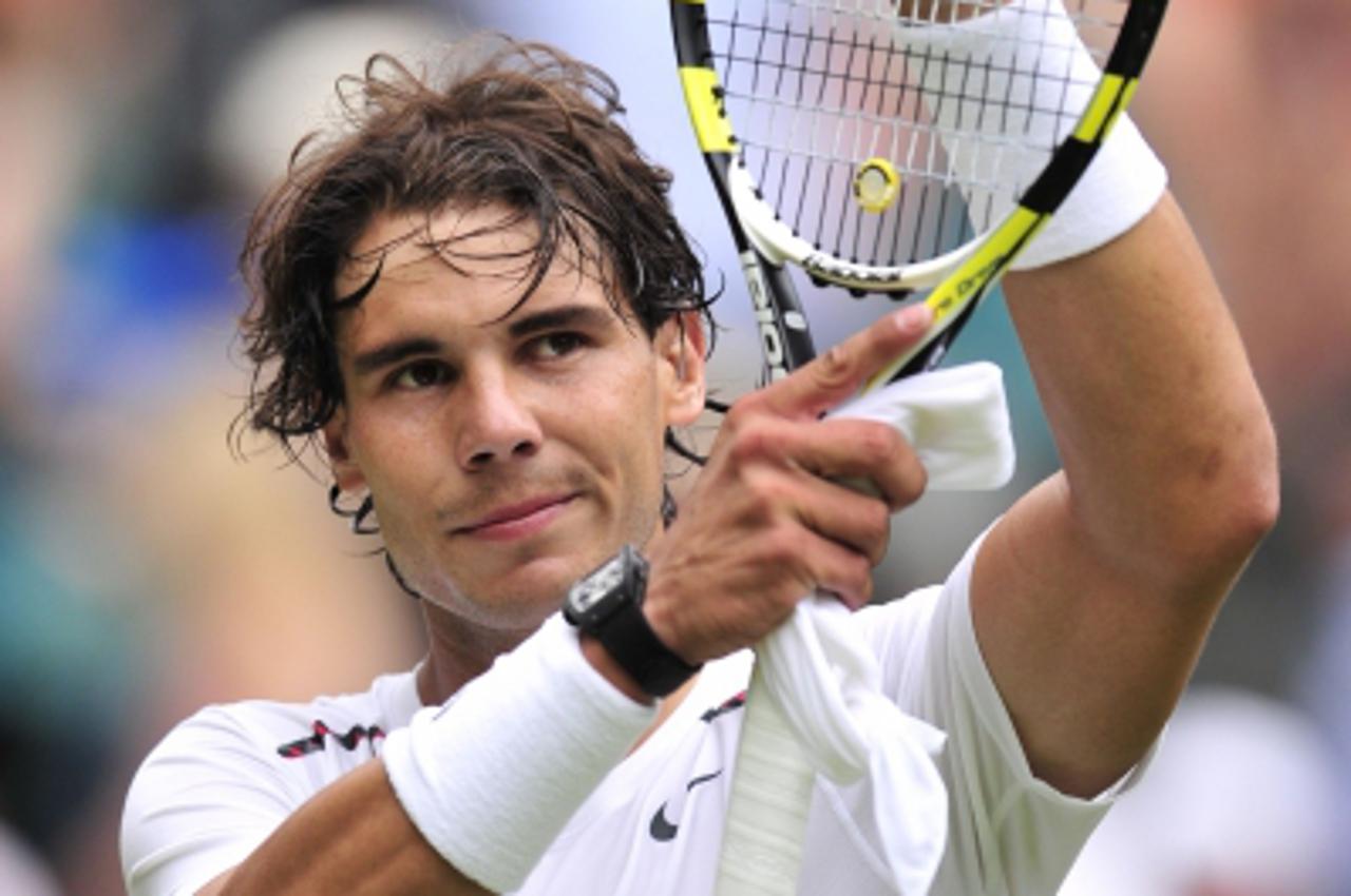 ' (FILES) This file picture taken on June 26, 2012 shows Spain\'s Rafael Nadal celebrating his first round men\'s singles victory over Brazil\'s Thomaz Bellucci on the second day of the 2012 Wimbledon