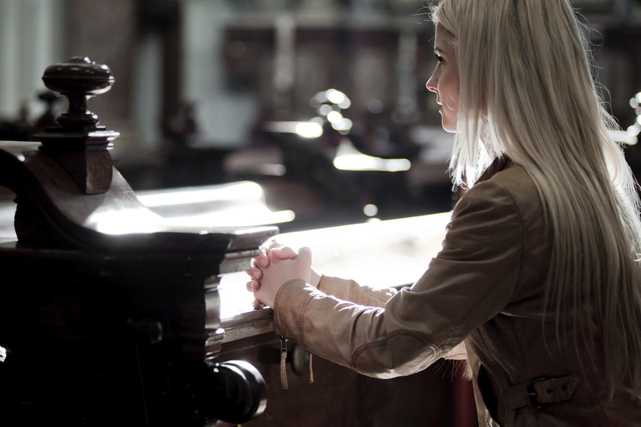 Woman praying in the Church