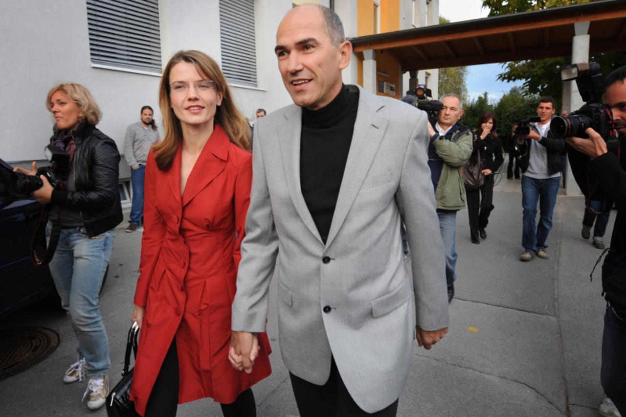 'Slovenian Prime Minister Janez Jansa and his wife Urska smile as they leave polling station in Grosuplje, some 20 kilometers from capital Ljubljana, on September 21, 2008. Slovenia voted today in par