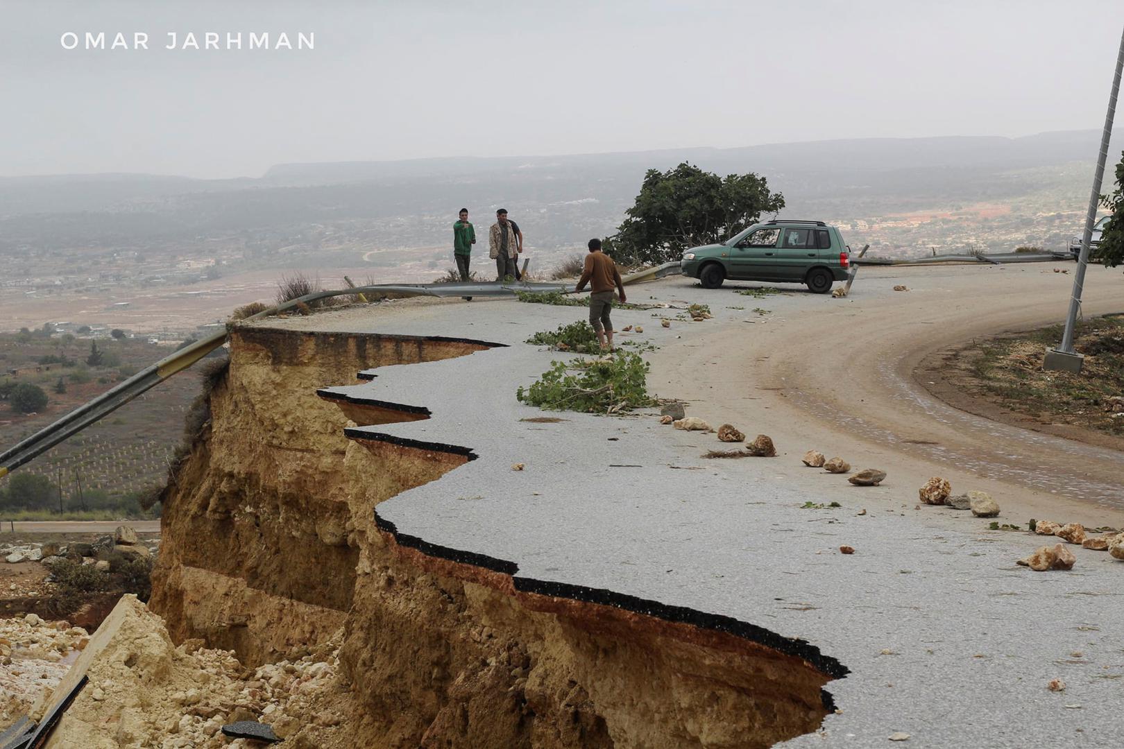 People stand in a damaged road as a powerful storm and heavy rainfall flooded hit Shahhat city, Libya, September 11, 2023. REUTERS/Omar Jarhman NO RESALES. NO ARCHIVES. WATERMARK ADDED AT SOURCE. Photo: Stringer/REUTERS