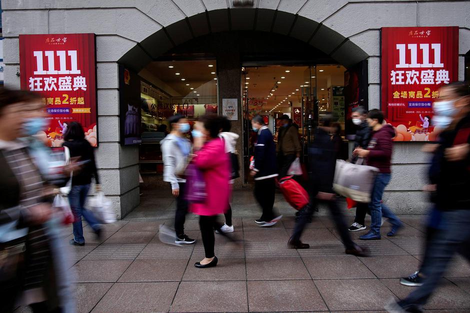 FILE PHOTO: People walk along a main shopping area during the Alibaba's Singles' Day shopping festival in Shanghai