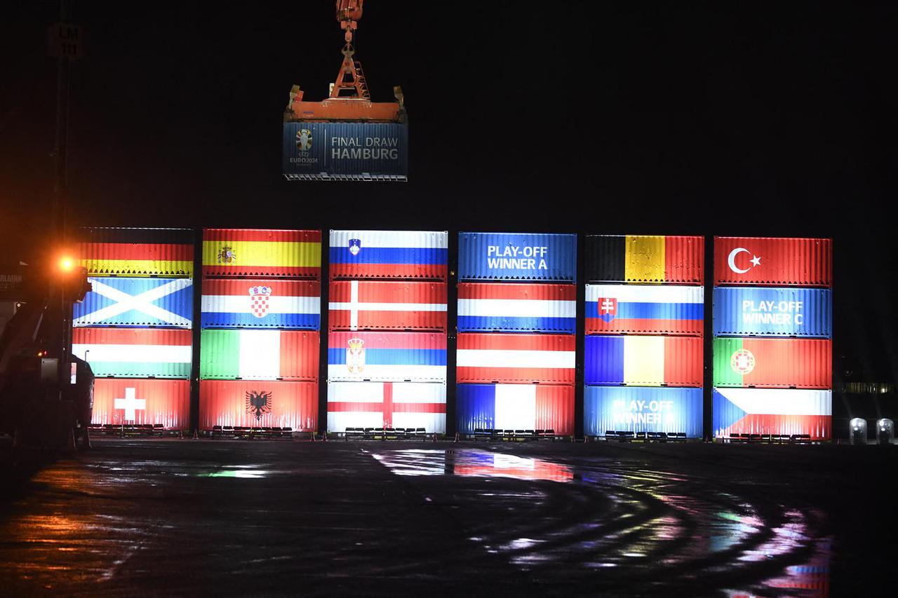 Port workers in Hamburg stack containers with flags of the Euro 2024 teams in accordance with the Euro 2024 draw