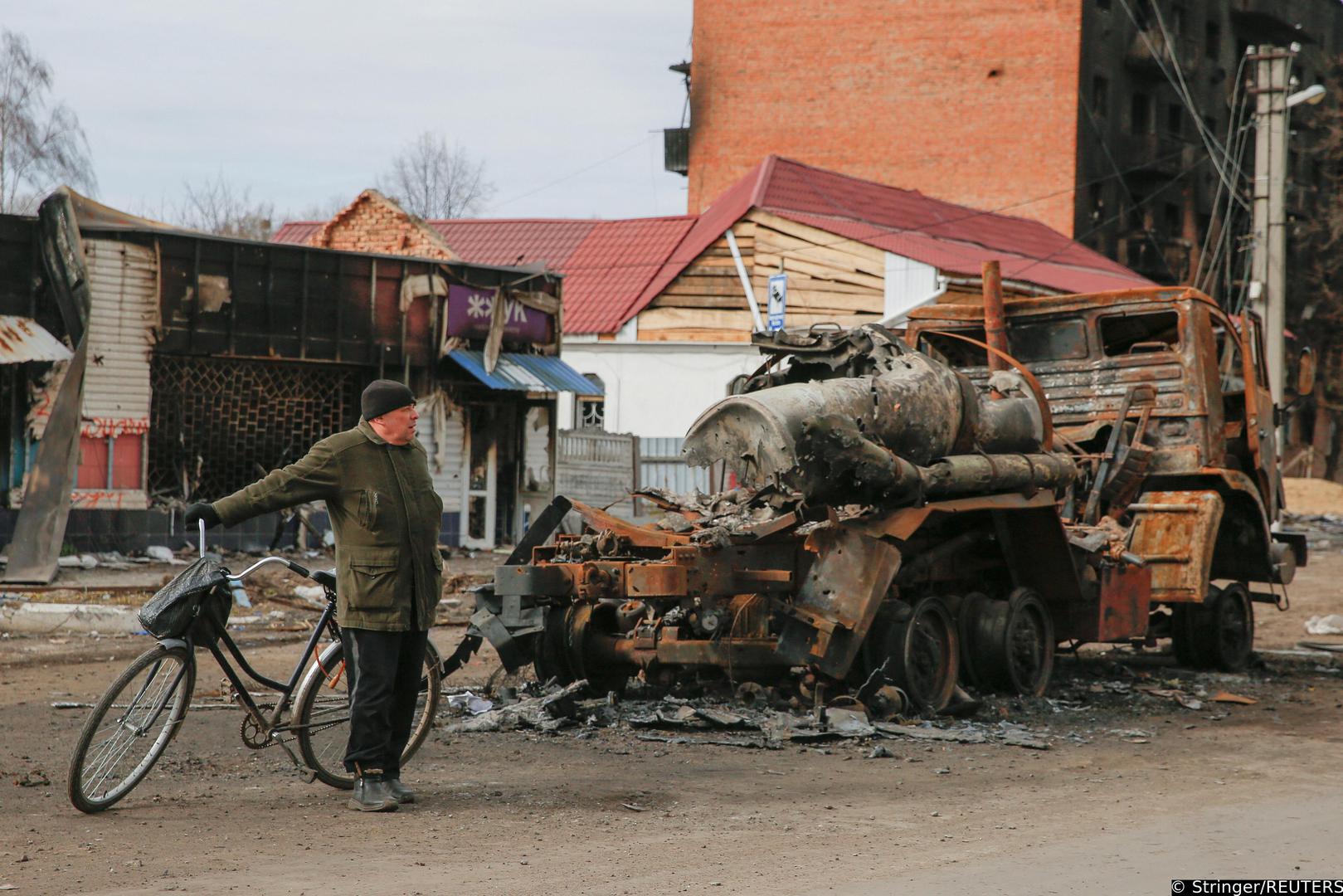 A local resident stands next to a destroyed Russian military vehicle, as Russia?s attack on Ukraine continues, in the town of Trostianets, in Sumy region, Ukraine March 28, 2022. Picture taken March 28, 2022. REUTERS/Oleg Pereverzev Photo: Stringer/REUTERS