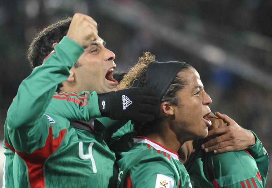 'Mexico\'s defender Rafael Marquez (L) and Mexico\'s striker Giovani dos Santos celebrate after Mexico\'s striker Cuauhtemoc Blanco (unseen) scored a penalty shot during the Group A first round 2010 W