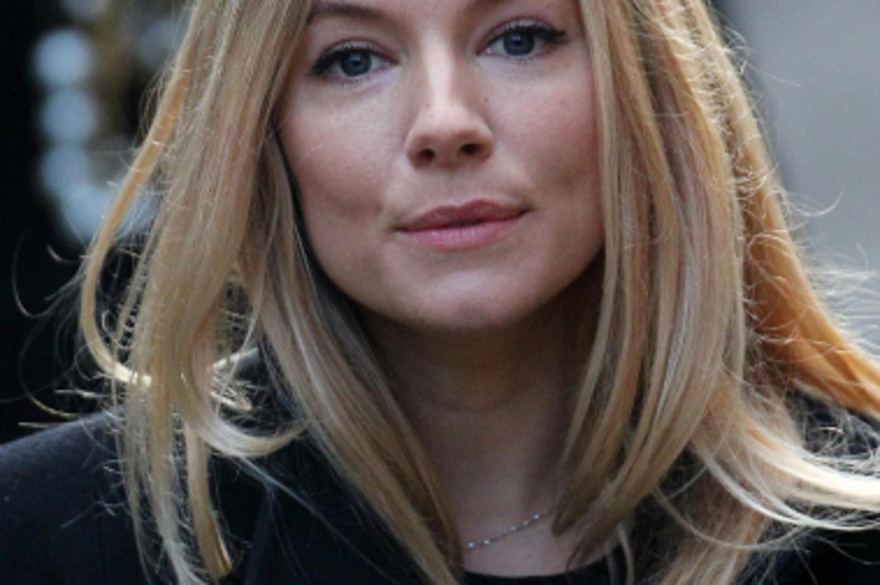 'Actress Sienna Miller arrives at the Royal Courts of Justice in London to give evidence to the Leveson Inquiry about her experiences of media intrusion. Photo: Press Association/Pixsell'