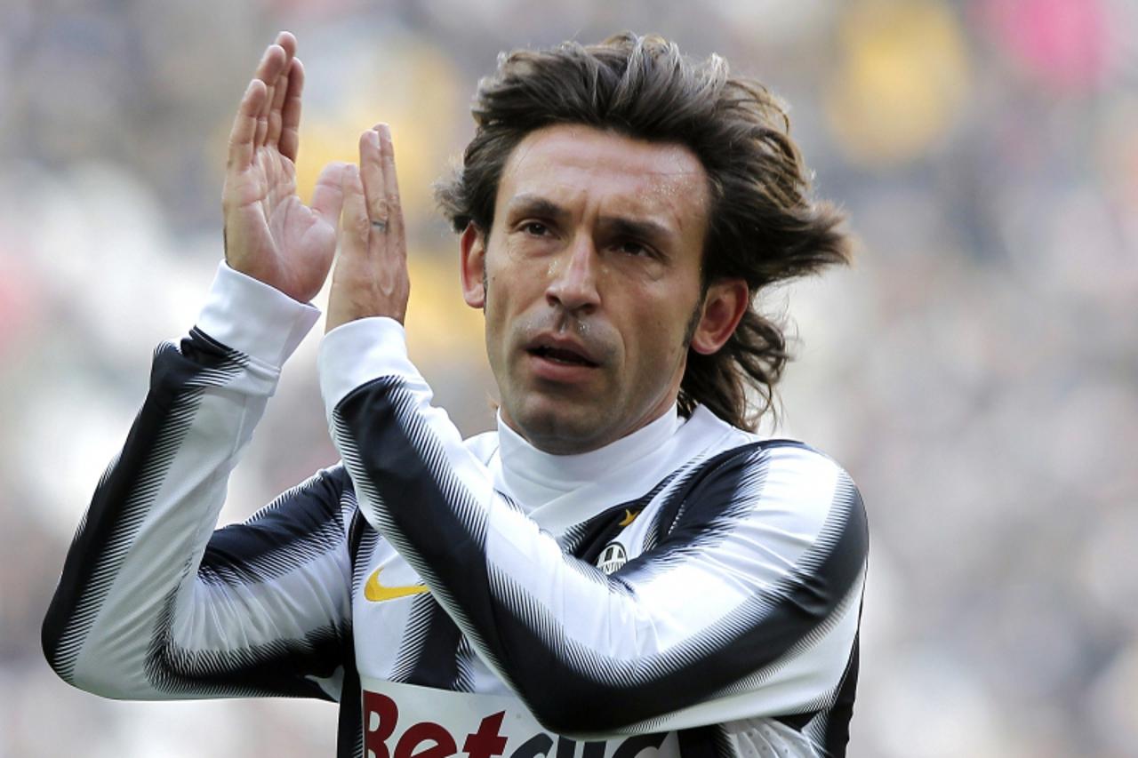 'Juventus\' Andrea Pirlo applauds during the Italian serie A football match between Juventus and Cagliari at the Juventus Stadium in Turin on January 15, 2012. AFP PHOTO / FABIO MUZZI'