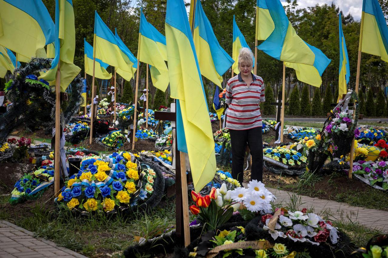 Local woman Larissa visits the graves of people she grew up with and died in fighting in the war, amid Russia’s attack on Ukraine, in a cemetery outside Kramatorsk, Ukraine