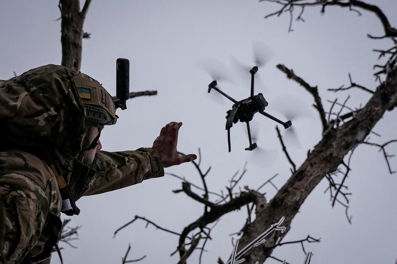 Ukrainian serviceman launches a kamikaze FPV drone at a front line near the city of Bakhmut