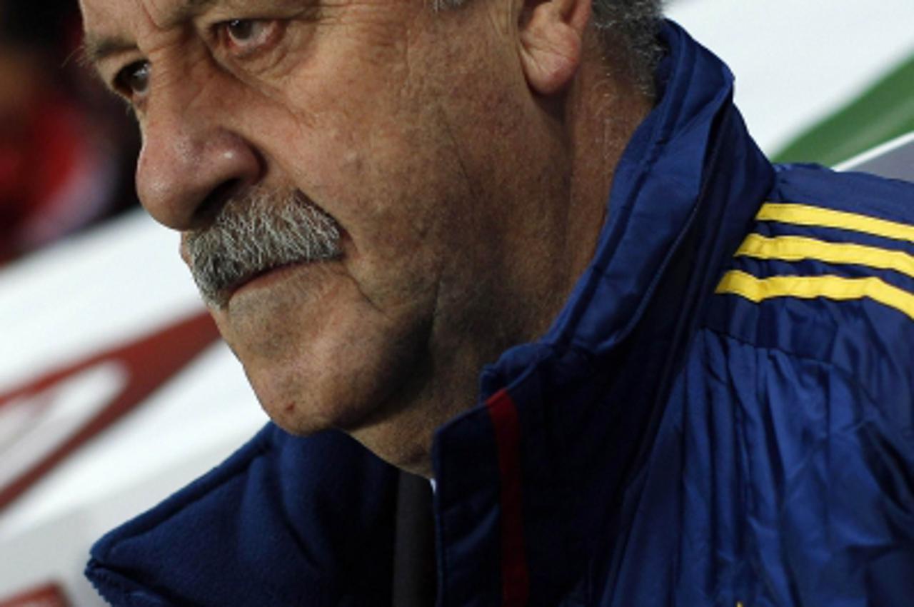 'Spain\'s coach Vicente del Bosque listens to their national anthem before their international friendly soccer match against Venezuela at La Rosaleda stadium in Malaga, southern Spain February 29, 201