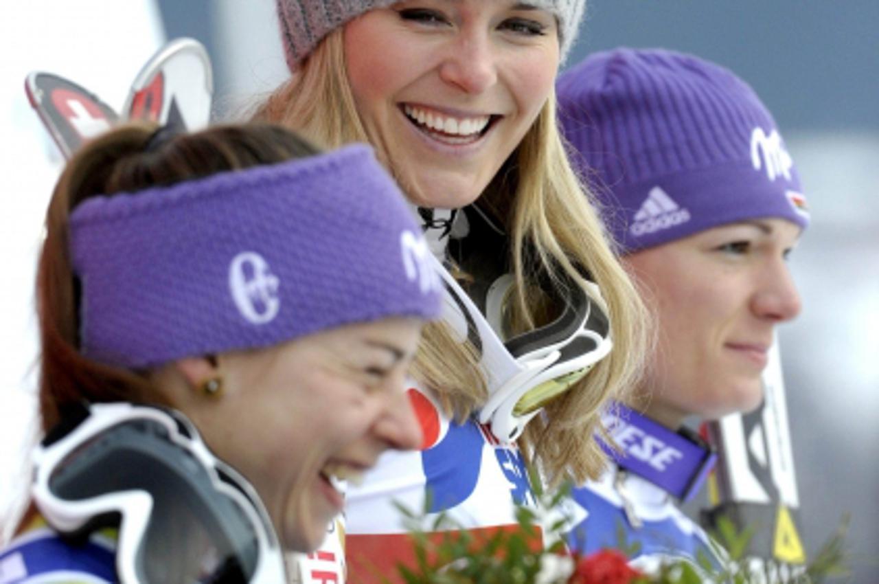 'Second-placed Tina Maze from Slovenia (L), winner Lindsey Vonn from the U.S. (C) and 3rd placed Maria Riesch from Germany (R) pose on the podium after the women\'s World Cup downhill ski race in Are 