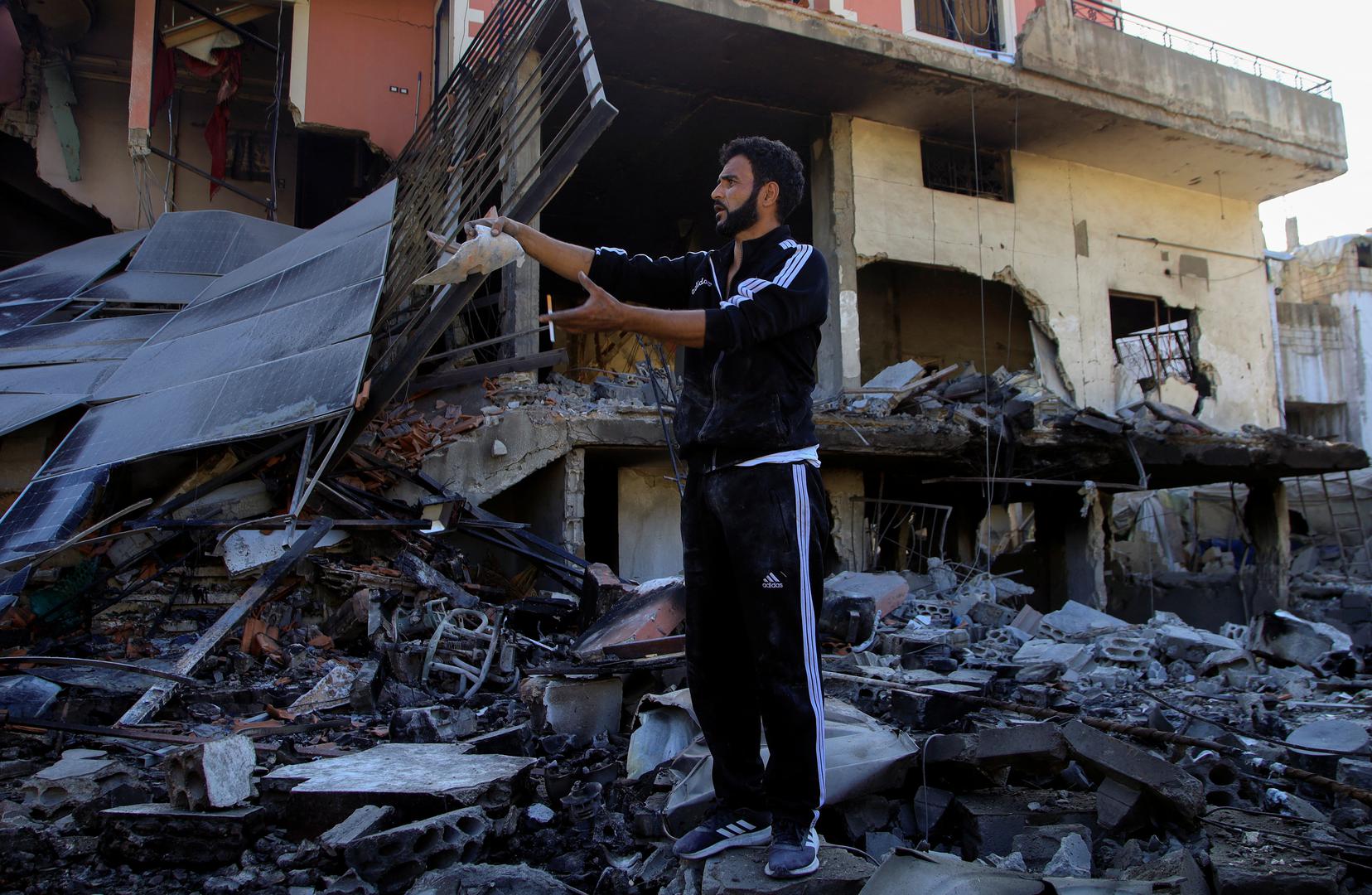 A man stands on the rubble of a damaged building, in the Lebanese southern village of Akbiyeh, amid ongoing cross-border hostilities between Hezbollah and Israeli forces, Lebanon, September 24, 2024. REUTERS/Stringer Photo: Stringer/REUTERS