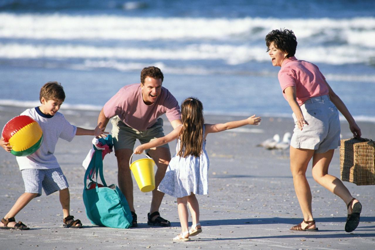 'Family playing on beach'