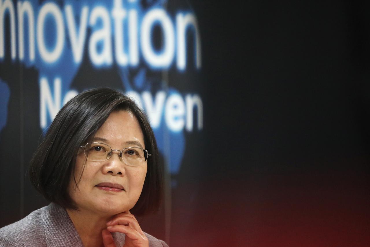 Taiwanese president Tsai Ing-Wen listens to a presentation at a non woven filter fabric factory, where the fabric is used to make surgical face masks, in Taoyuan, Taiwan,