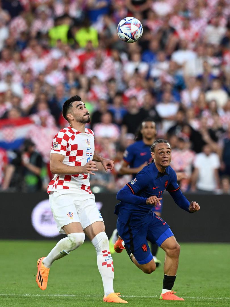 14.06.2023., stadion Feyenoord "De Kuip", Rotterdam, Nizozemska - UEFA Liga Nacija, polufinale, Nizozemska - Hrvatska. Josip Sutalo, Xavi Simons Photo: Marko Lukunic/PIXSELL