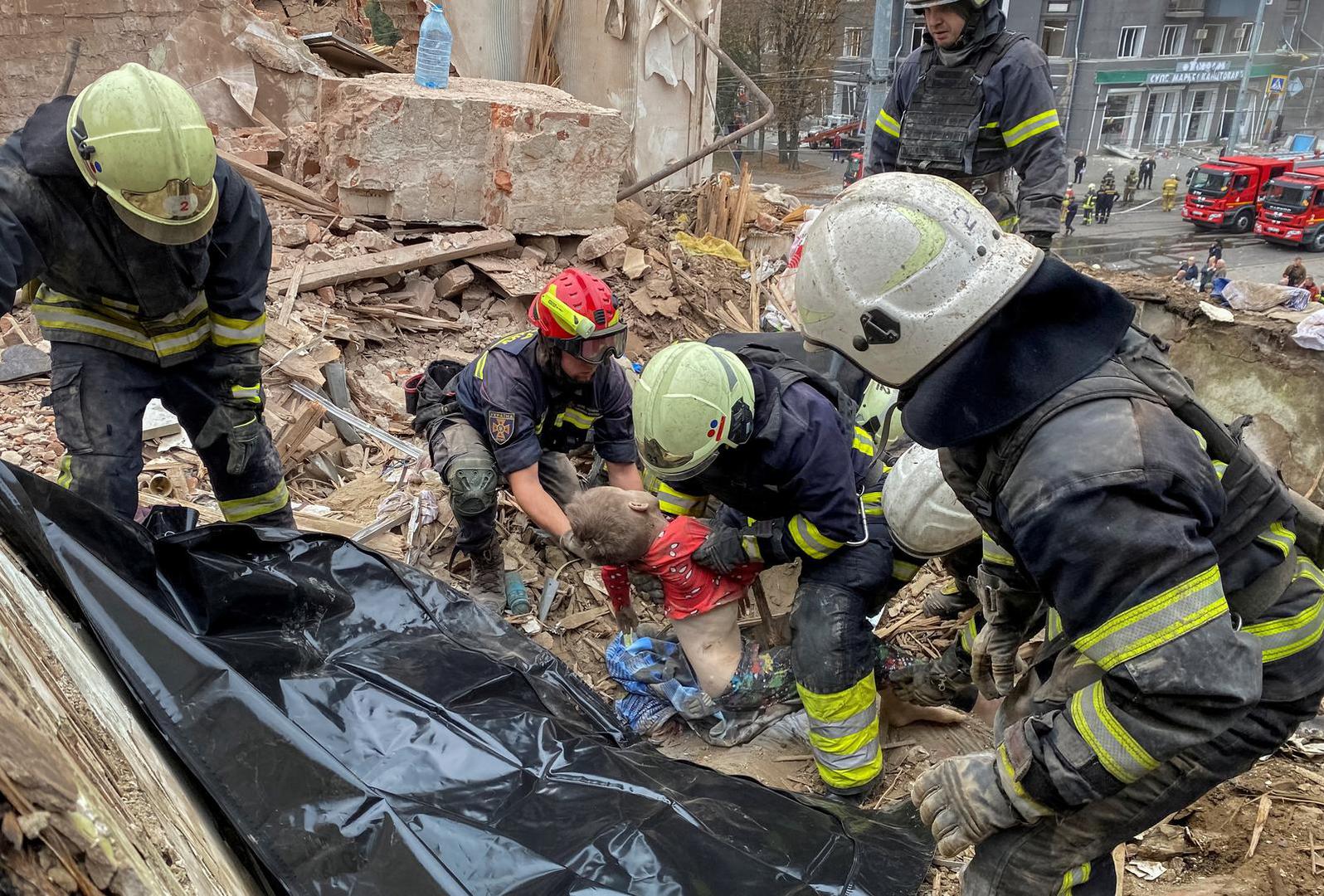 SENSITIVE MATERIAL. THIS IMAGE MAY OFFEND OR DISTURB    Rescues release the body of a 10-year-old boy, Tymofii Bychko, from debris, at a site of a residential building damaged by a Russian missile strike, amid Russia's attack on Ukraine, in Kharkiv, Ukraine October 6, 2023. REUTERS/Vitalii Hnidyi Photo: Stringer/REUTERS