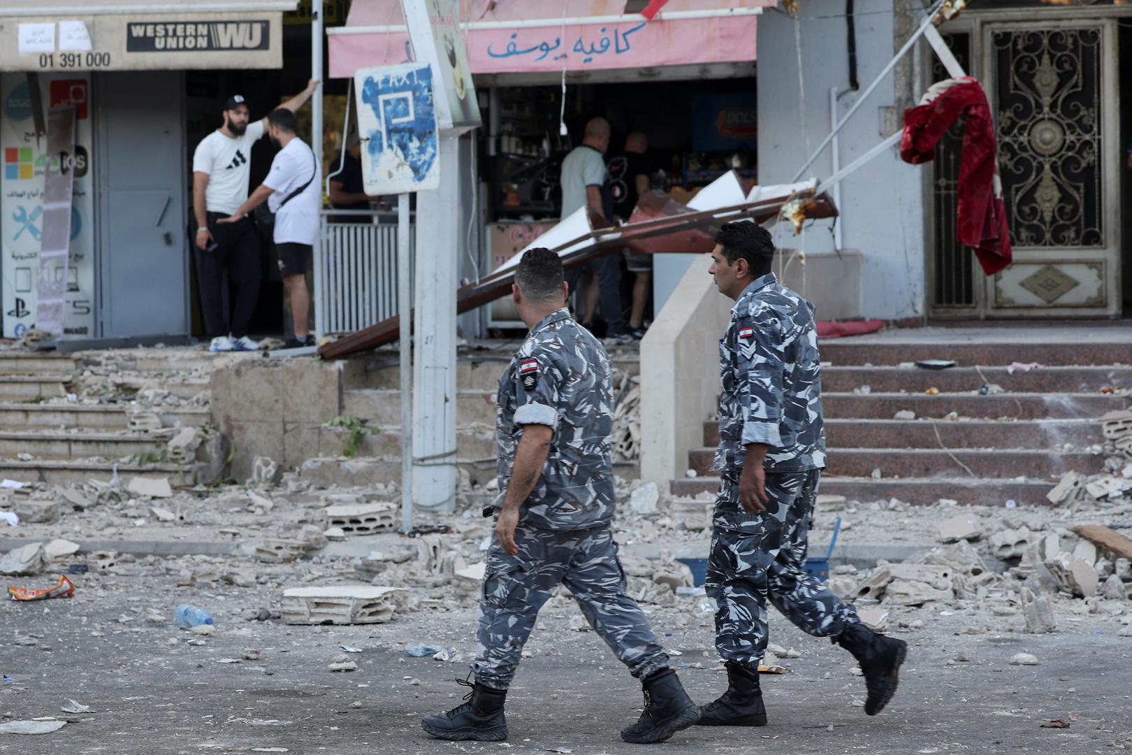 Members of the Lebanese Internal Security Forces walk past a debris-strewn street following an Israeli strike, amid ongoing cross-border hostilities between Hezbollah and Israeli forces, in Kola, central Beirut, Lebanon September 30, 2024. REUTERS/Louisa Gouliamaki Photo: LOUISA GOULIAMAKI/REUTERS