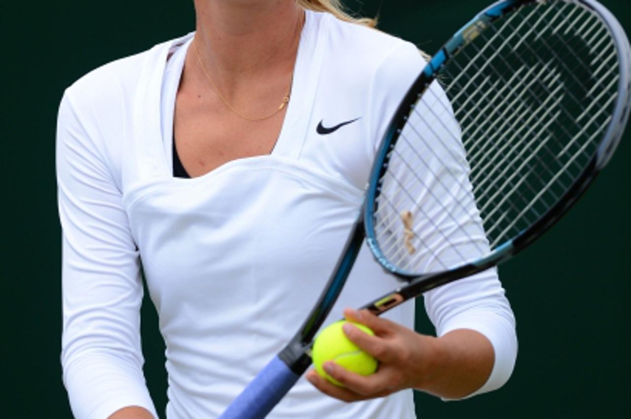 'Russia\'s Maria Sharapova prepares to serve during a practice session on Court 11 on day seven of the 2012 Wimbledon Championships tennis tournament at the All England Tennis Club in Wimbledon, south