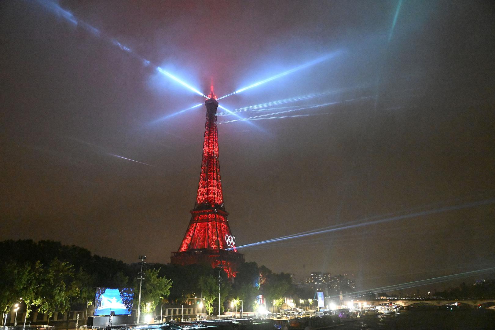 Paris 2024 Olympics - Opening Ceremony - Paris, France - July 26, 2024. A light show is staged on the Eiffel Tower during the opening ceremony of the Paris 2024 Olympic Games in Paris, France, July 26, 2024.     Li An/Pool via REUTERS Photo: Li An/REUTERS