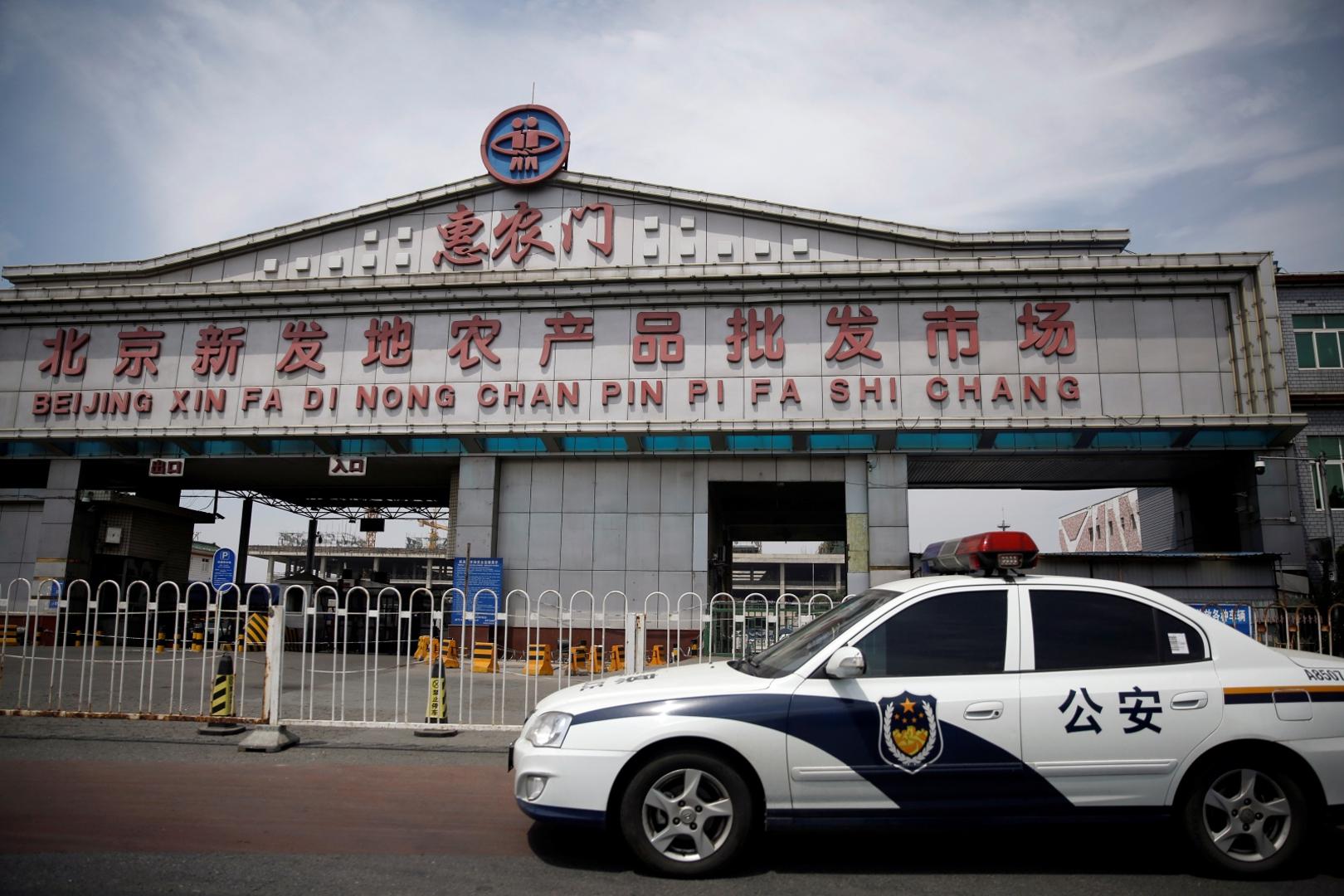 Police vehicle is seen outside an entrance of the Xinfadi wholesale market, which has been closed following cases of coronavirus disease (COVID-19) infections, in Beijing A police vehicle is seen outside an entrance of the Xinfadi wholesale market, which has been closed following cases of coronavirus disease (COVID-19) infections, in Beijing, China June 16, 2020.  REUTERS/Tingshu Wang TINGSHU WANG