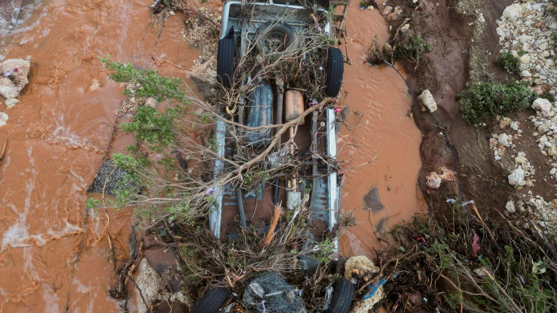 Aerial view of a damaged car and flood water on a road as a powerful storm and heavy rainfall hit Shahhat city, Libya, September 11, 2023. REUTERS/Ali Al-Saadi. NO RESALES. NO ARCHIVES Photo: Stringer/REUTERS