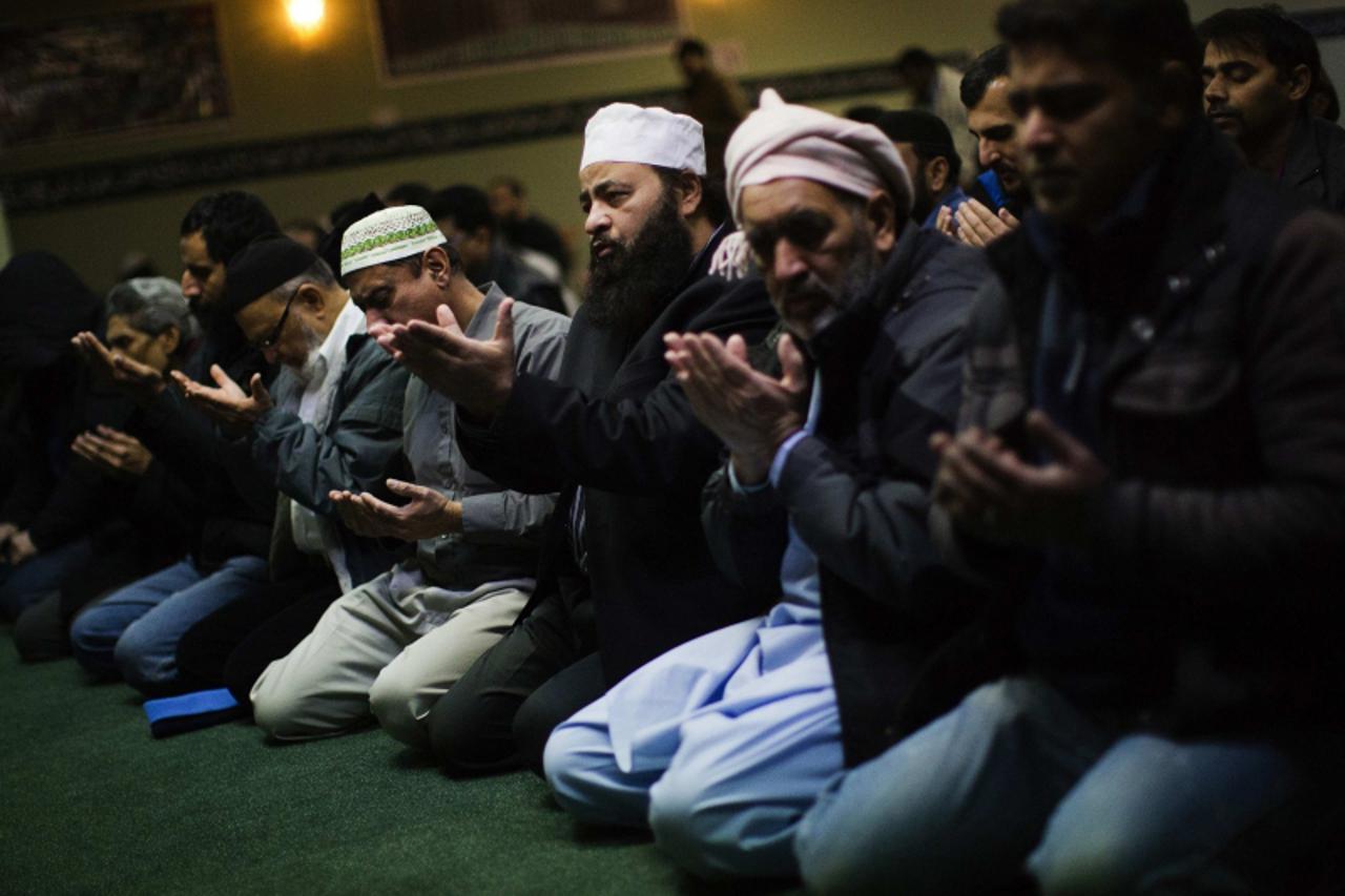 'Worshippers take part in Friday prayers inside the mosque at the Mississauga Muslim Community Centre in Mississauga, Ontario January 18, 2013. Sufi cleric and leader of the Minhaj-ul-Quran religious 