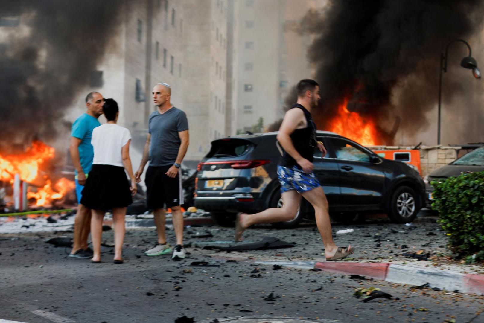 People react on the road, in the aftermath of rocket barrages that were launched from Gaza, in Ashkelon, Israel October 7, 2023. REUTERS/Amir Cohen Photo: AMIR COHEN/REUTERS