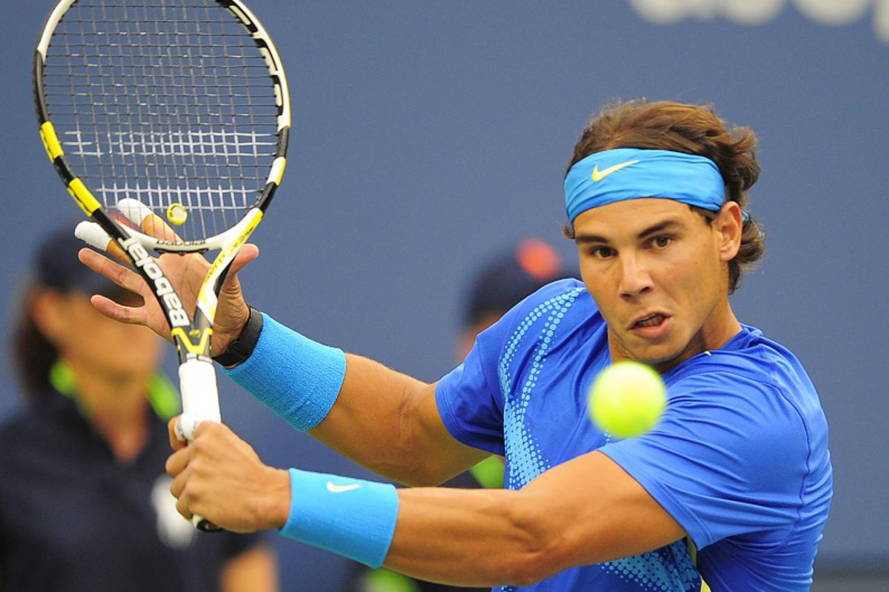 'Spanish tennis player Rafael Nadal returns a shot to Great Britain\'s Andy Murray during their Men\'s US Open 2011 semifinals match at the USTA Billie Jean King National Tennis Center in New York Sep