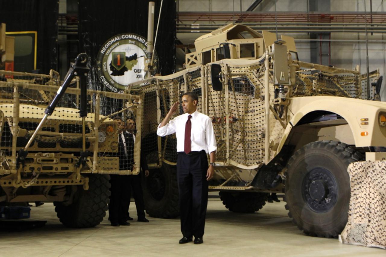 \'U.S. President Barack Obama salutes troops at Bagram Air Base in Kabul, May 2, 2012.  Earlier, Obama and Afghan President Hamid Karzai signed the Strategic Partnership Agreement at the Presidential 