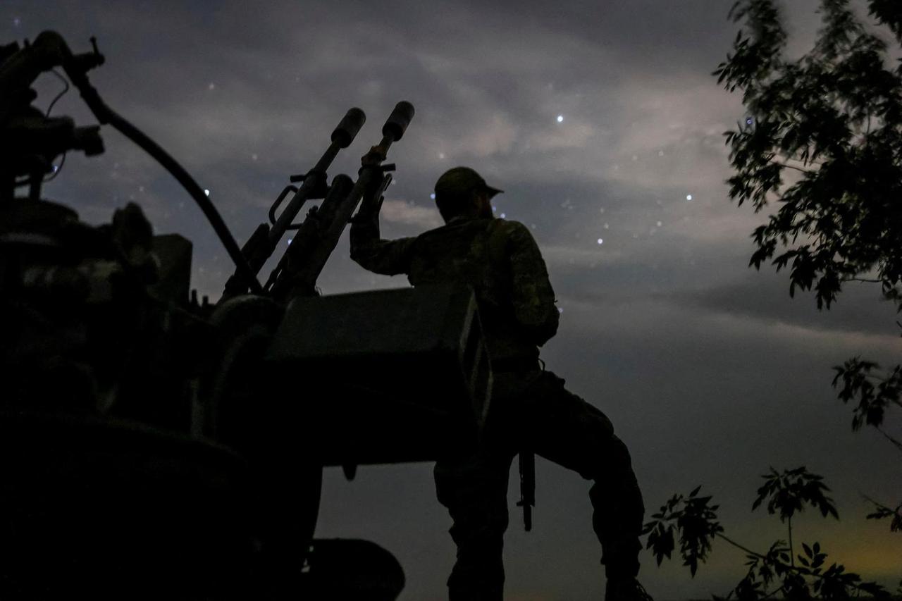 FILE PHOTO: A Ukrainian serviceman from an anti-drone mobile air defence unit stands near an anti aircraft cannon as he waits for Russian kamikaze drones in Kherson region