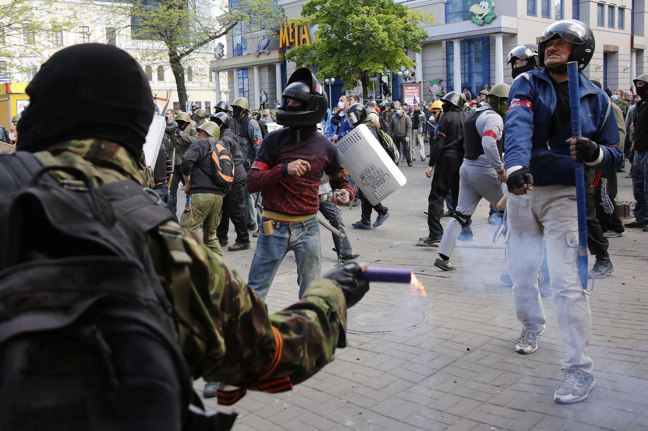 Pro-Russian activists hurl objects at supporters of the Kiev government during clashes in the streets of Odessa May 2, 2014. Police said a man was shot dead in clashes between a crowd backing Kiev and pro-Russian activists in the largely Russian-speaking 