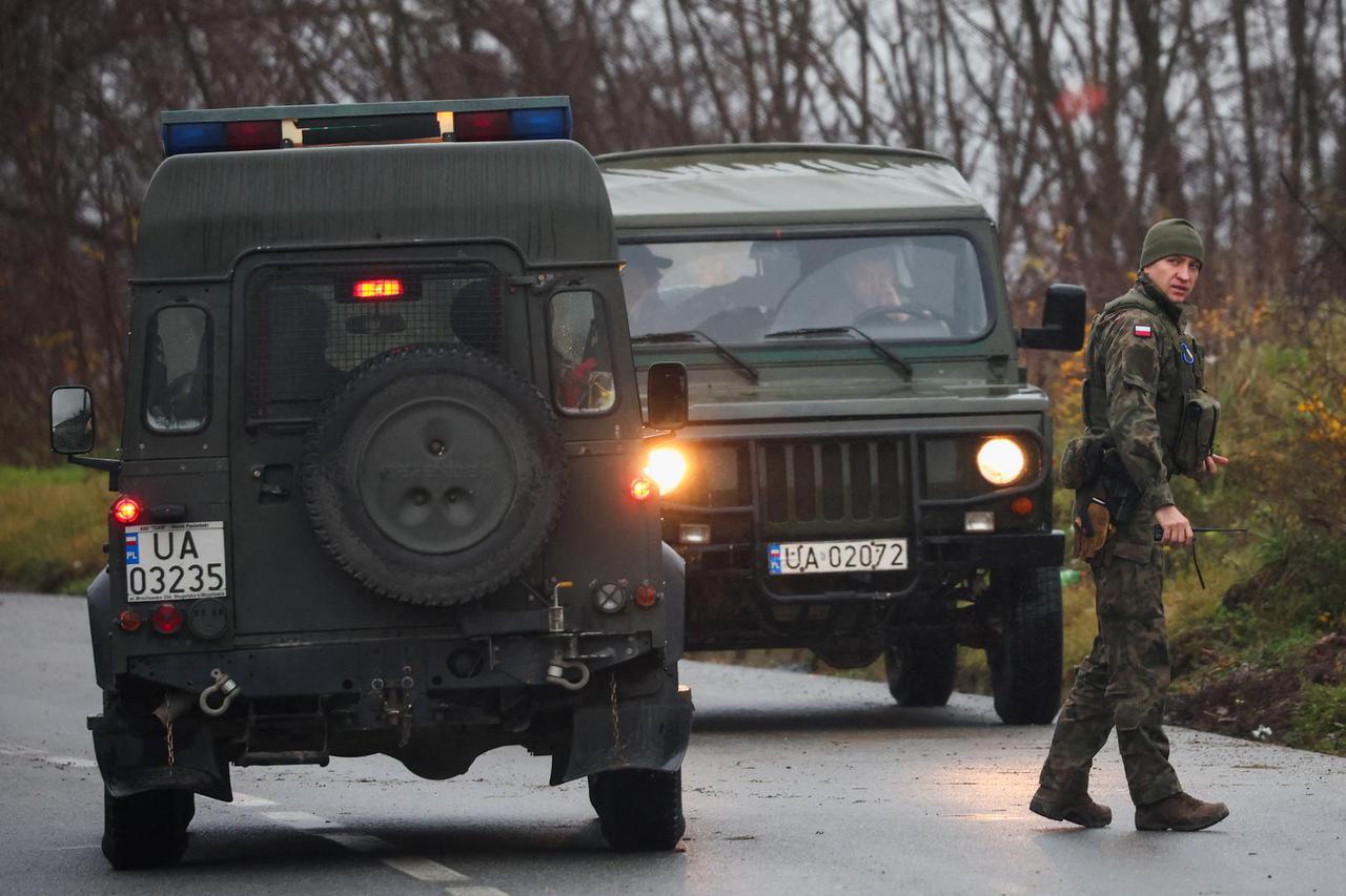 A member of the Polish Armed Forces walks near a roadblock set up by local Serbs, in Rudare