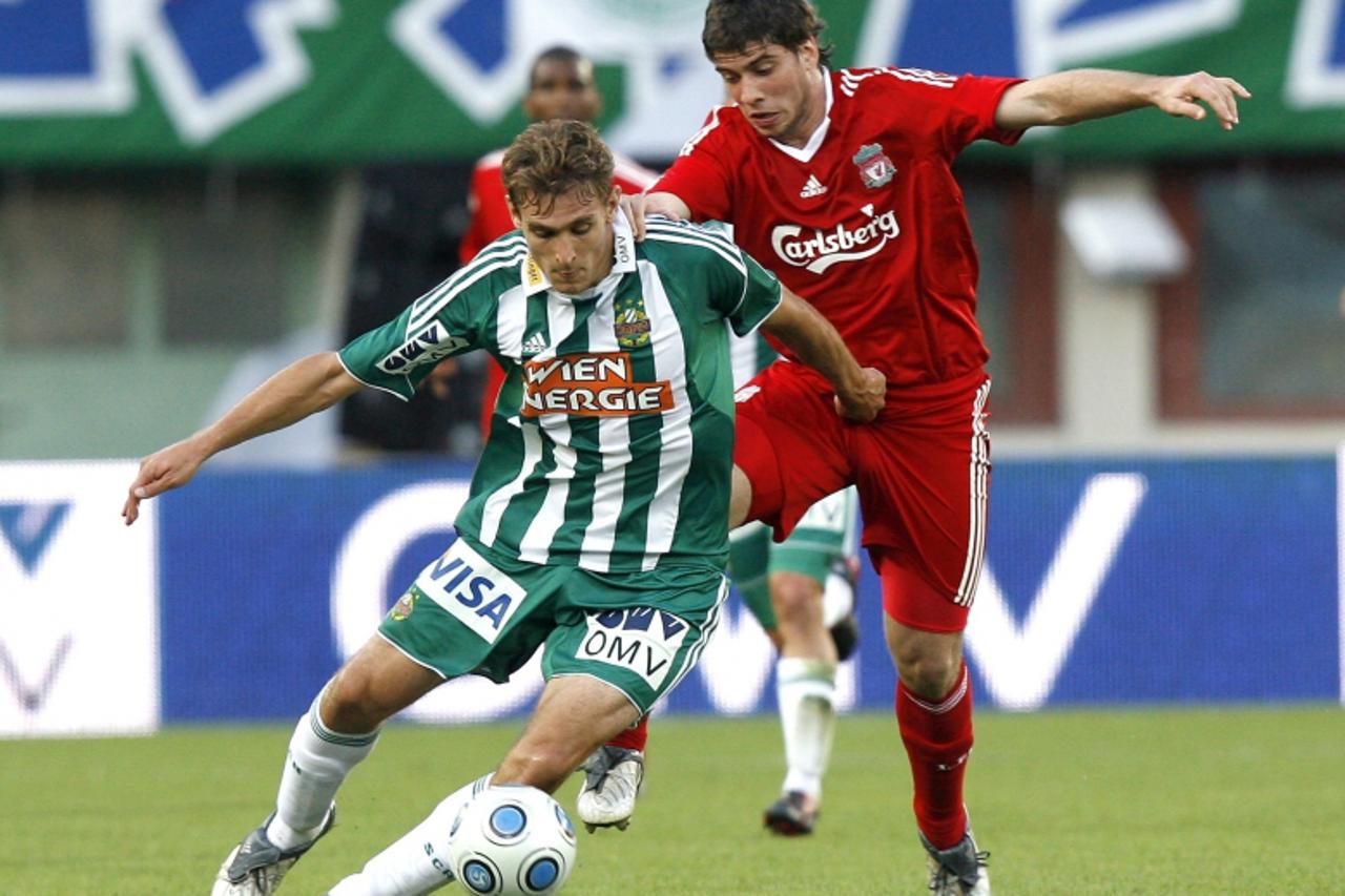 'Rapid\'s Nikica Jelavic (L) challenges Liverpool\'s Emiliano Insua during their friendly soccer match celebrating Rapid\'s 110 year anniversary in Vienna July 19, 2009.       REUTERS/Robert Zolles (A