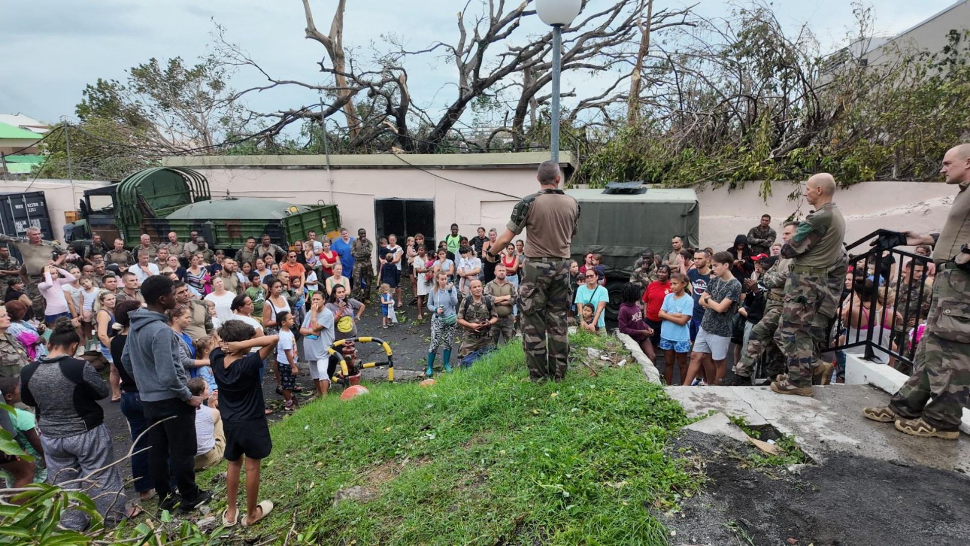 People gather near army personnel, in the aftermath of Cyclone Chido, in Mayotte, France, December 16, 2024. Etat-major des armees/Handout via REUTERS    THIS IMAGE HAS BEEN SUPPLIED BY A THIRD PARTY. NO RESALES. NO ARCHIVES. Photo: ETAT-MAJOR DES ARMEES/REUTERS