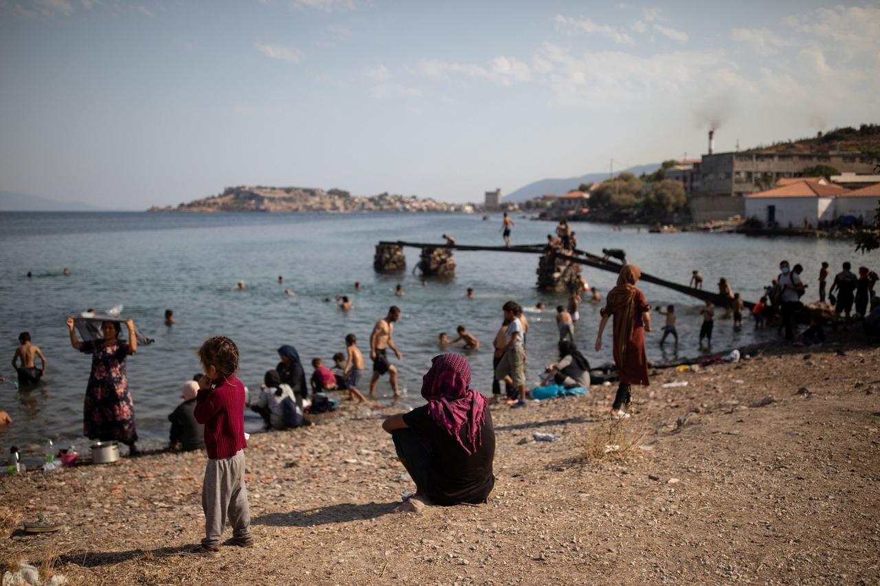 Refugees and migrants from the destroyed Moria camp enjoy the sea, on the island of Lesbos