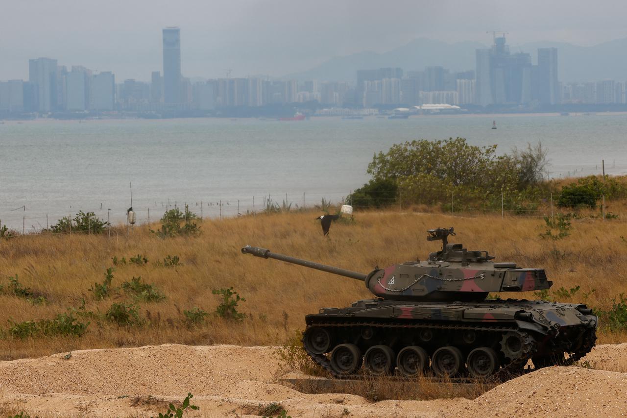 A retired military tank is seen on the beach with China in the background in Kinmen