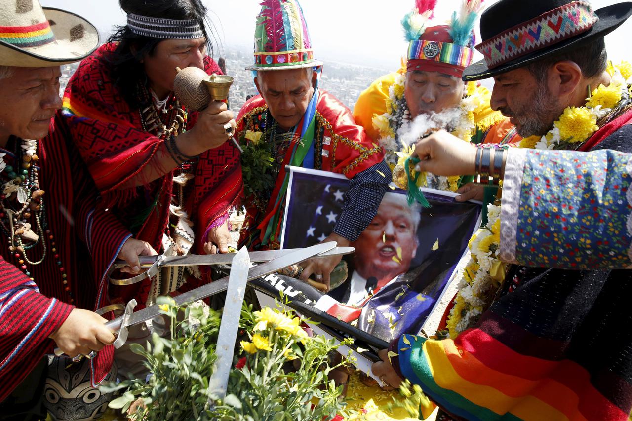 Peruvian shamans holding a poster of U.S. Republican presidential candidate Donald Trump perform a ritual of predictions for the new year at Morro Solar hill in Chorrillos, Lima, Peru, December 29, 2015. The ritual is an end-of-the-year tradition and the 