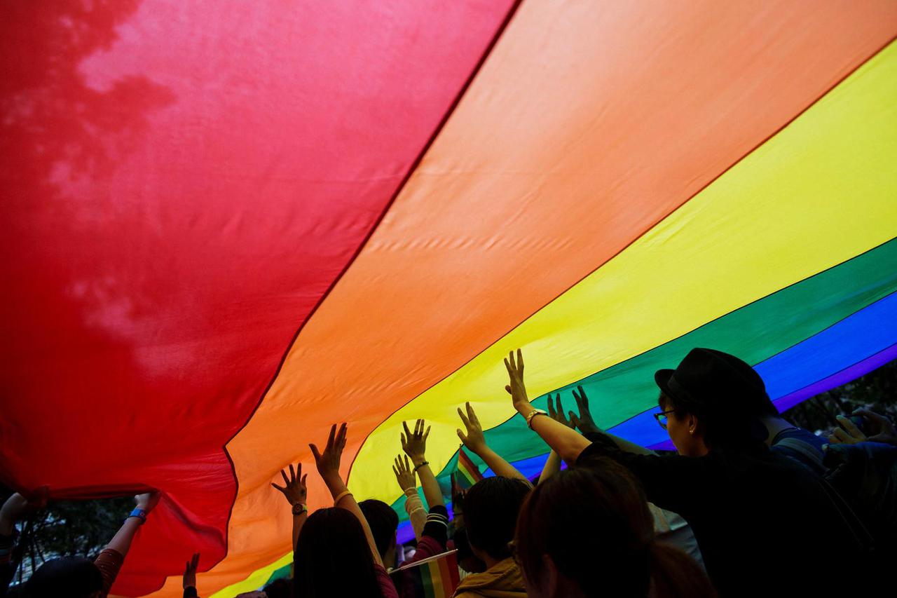 FILE PHOTO: Participants hold a giant rainbow flag during a lesbian, gay, bisexual and transgender (LGBT) Pride Parade in Hong Kong