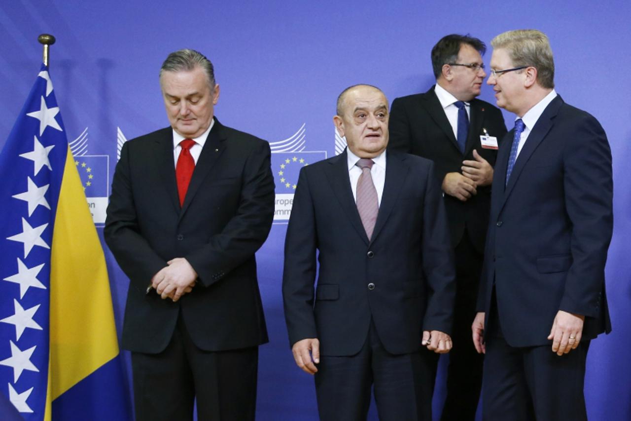 'European Enlargement Commissioner Stefan Fule (R) arrives to pose with Bosnian Prime Minister Vjekoslav Bevanda (C) and Foreign Minister Zlatko Lagumdzija (L) before talks on constitutional changes t