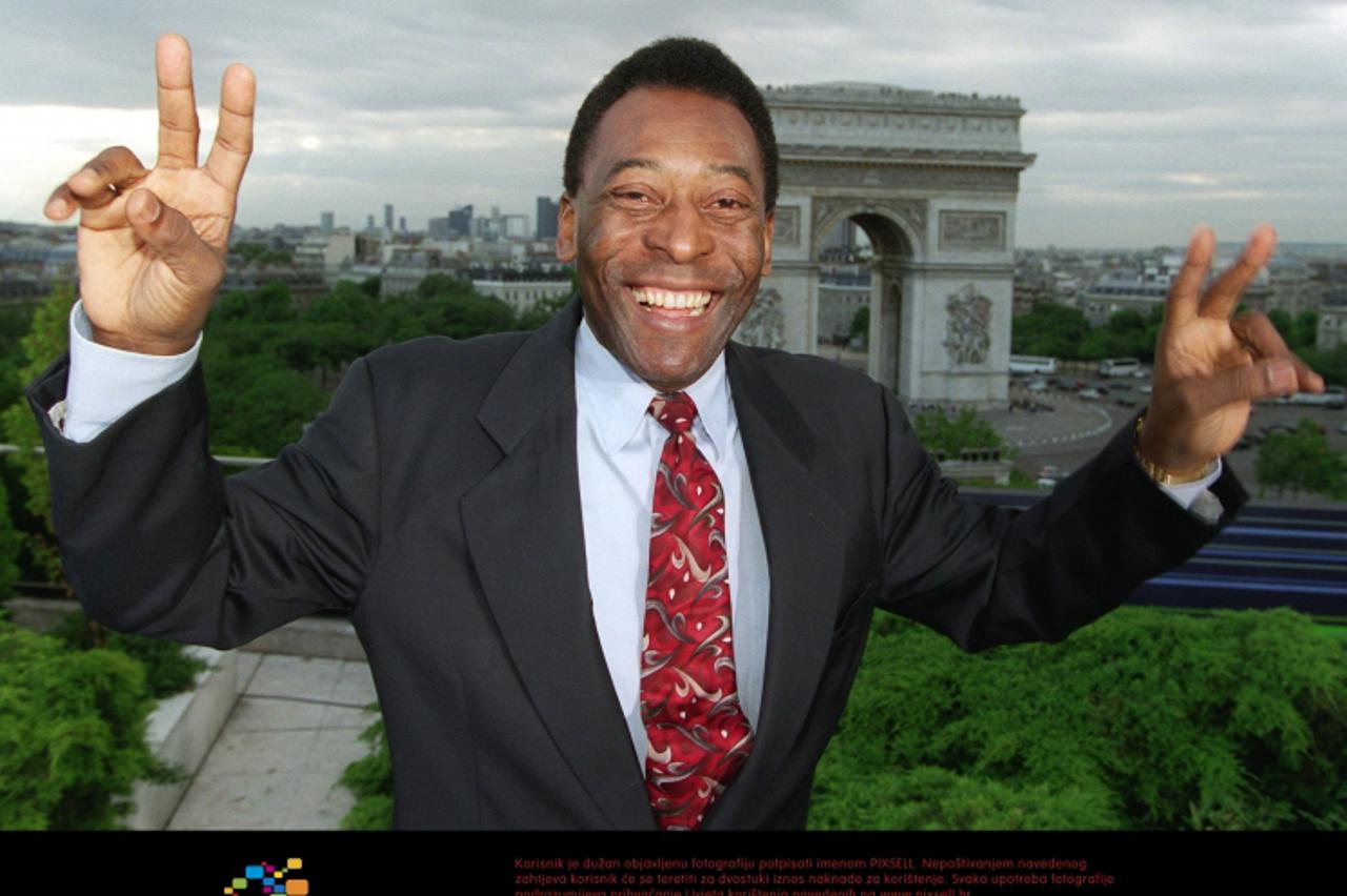 'Brazilian soccer legend Pele gestures with his arms and hands while he smiles and poses on a roof-top terrace of a hotel with a panoramic view of the Arc de Triomphe in Paris, France, 11 June 1998. T