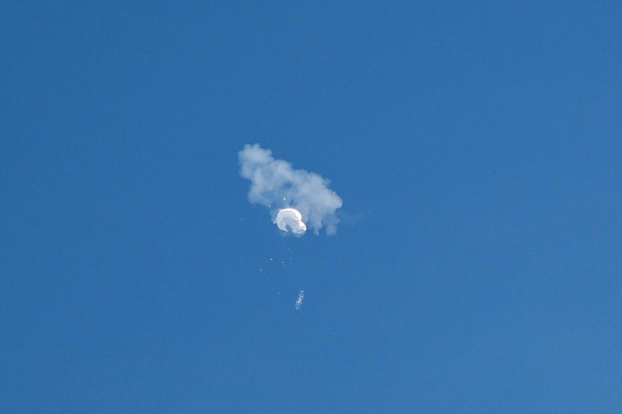 FILE PHOTO: A jet flies by a suspected Chinese spy balloon as it floats off the coast in Surfside Beach