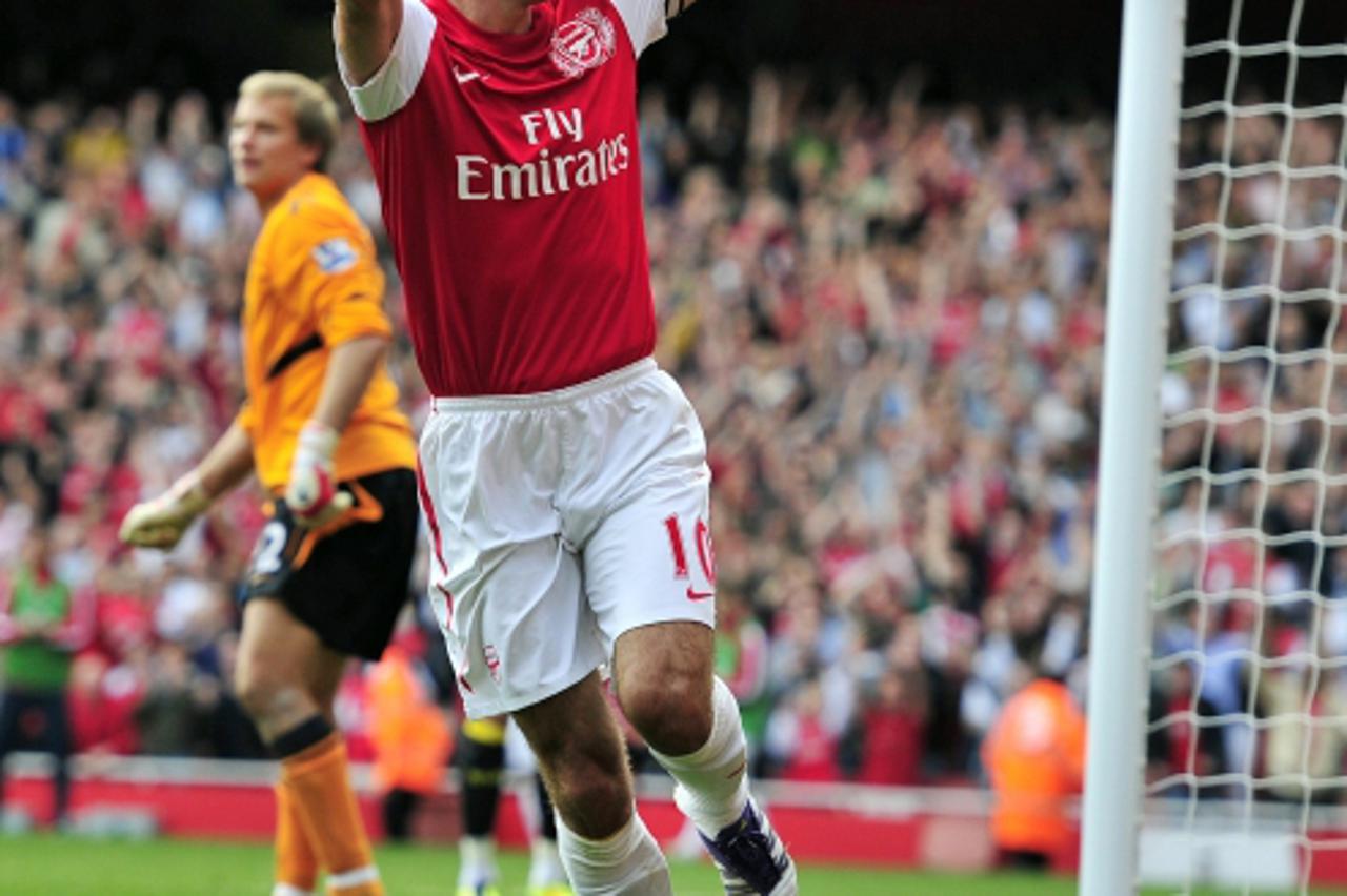 'Arsenal\'s Dutch striker Robin Van Persie celebrates scoring his second goal during the English Premier League football match between Arsenal and Bolton Wanderers at The Emirates Stadium in north Lon