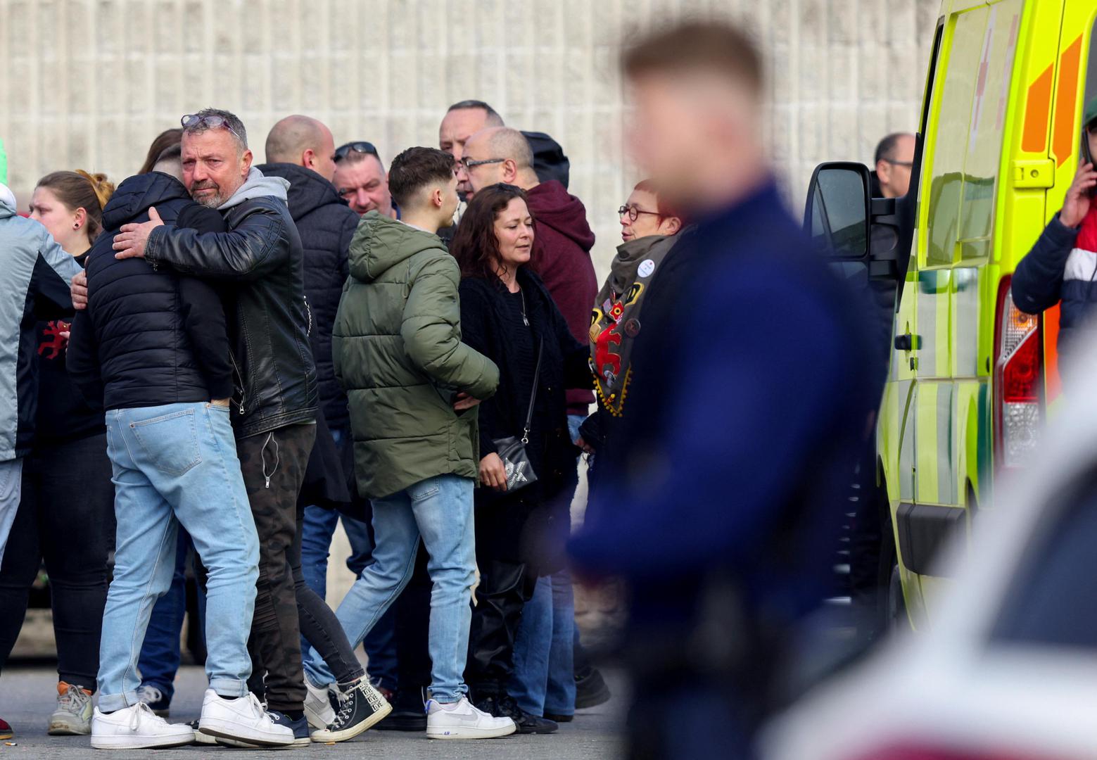 People react after a vehicle drove into a group of Belgian carnival performers who were preparing for a parade in the village of Strepy-Bracquegnies, Belgium March 20, 2022. REUTERS/Johanna Geron Photo: JOHANNA GERON/REUTERS