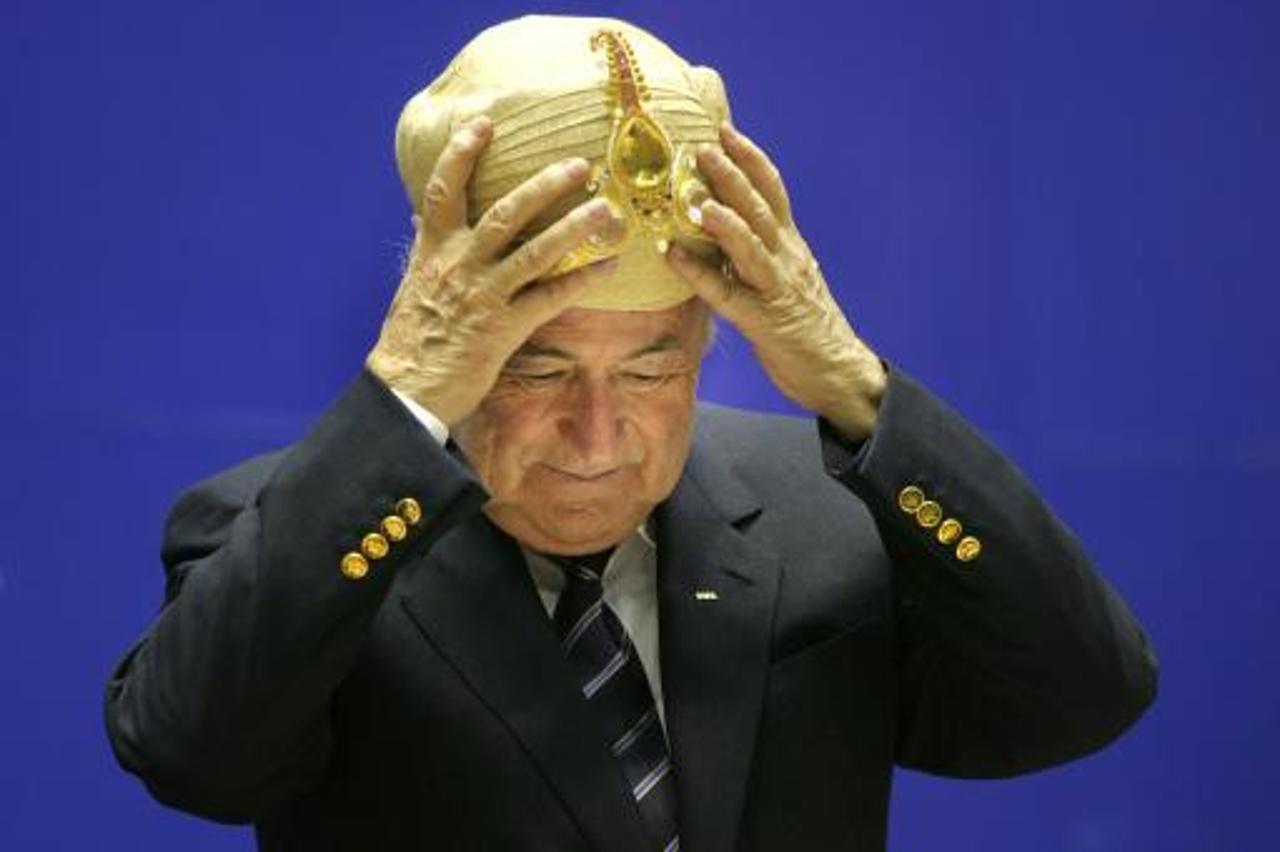 'Federation of International football Association, FIFA, President Joseph Sepp Blatter, gestures after being presented with a traditional Indian headgear at the 70th Anniversary of Indian Football, in