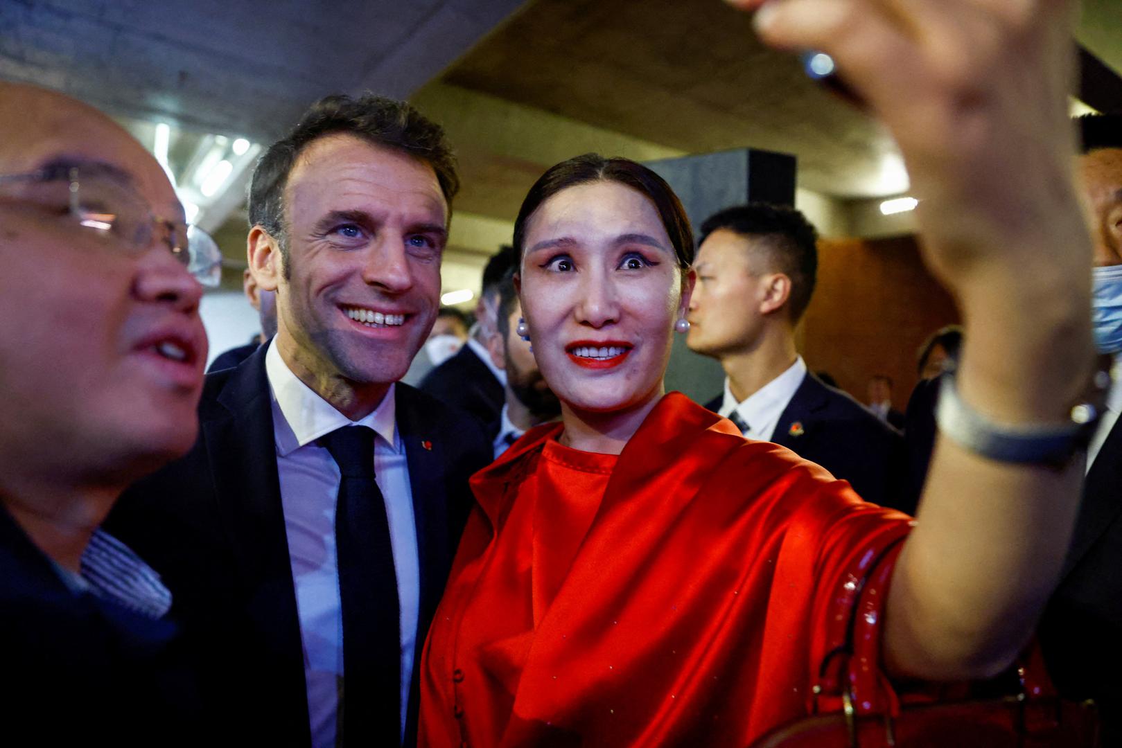 French President Emmanuel Macron takes pictures with attendees at the Red Brick Museum in Beijing, China, April 5, 2023. REUTERS/Gonzalo Fuentes     TPX IMAGES OF THE DAY Photo: GONZALO FUENTES/REUTERS