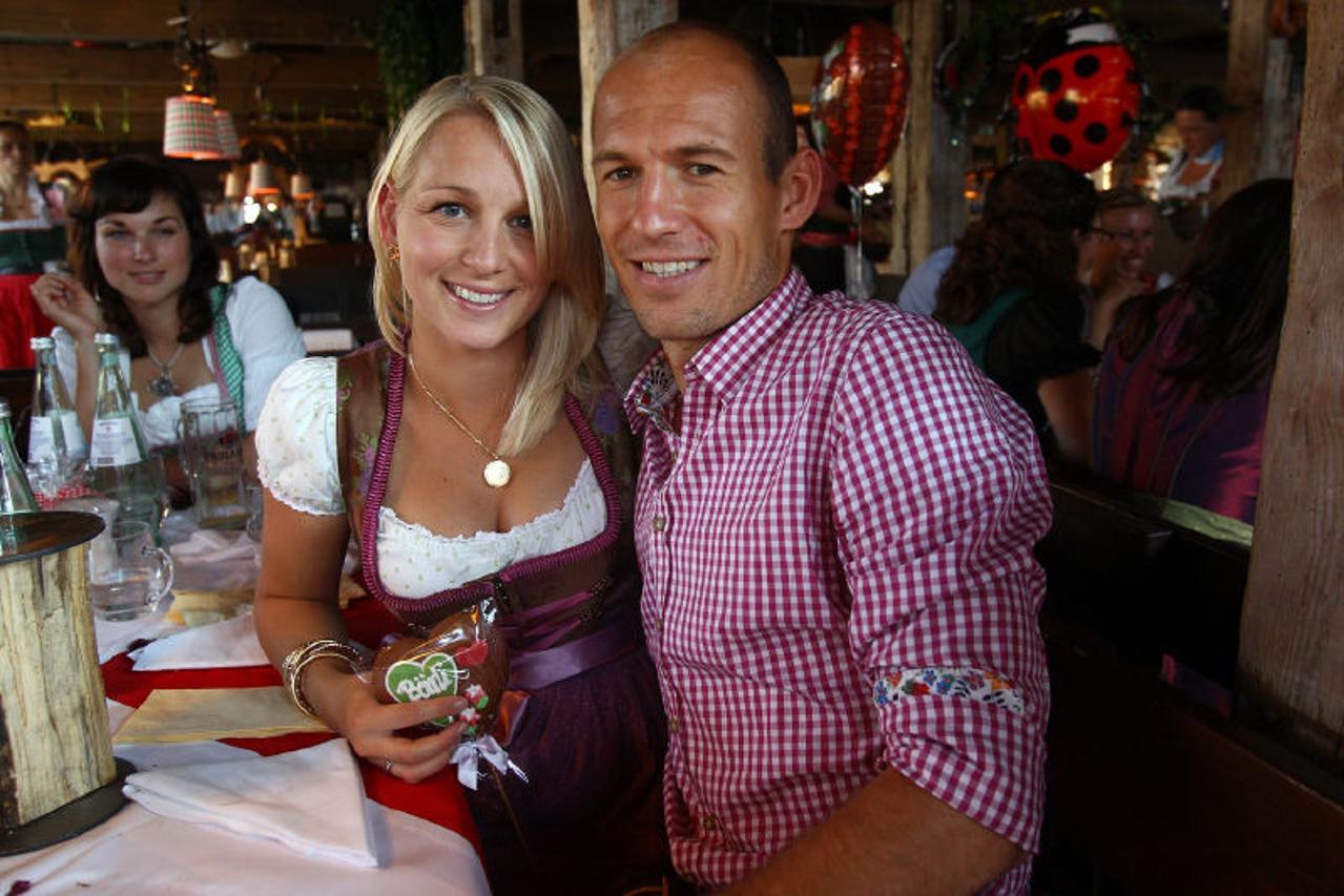 'MUNICH, GERMANY - OCTOBER 02:  Arjen Robben of FC Bayern Muenchen attends with Bernadien Robben the Oktoberfest beer festival at the Kaefer Wiesnschaenke tent on October 2, 2011 in Munich, Germany.  