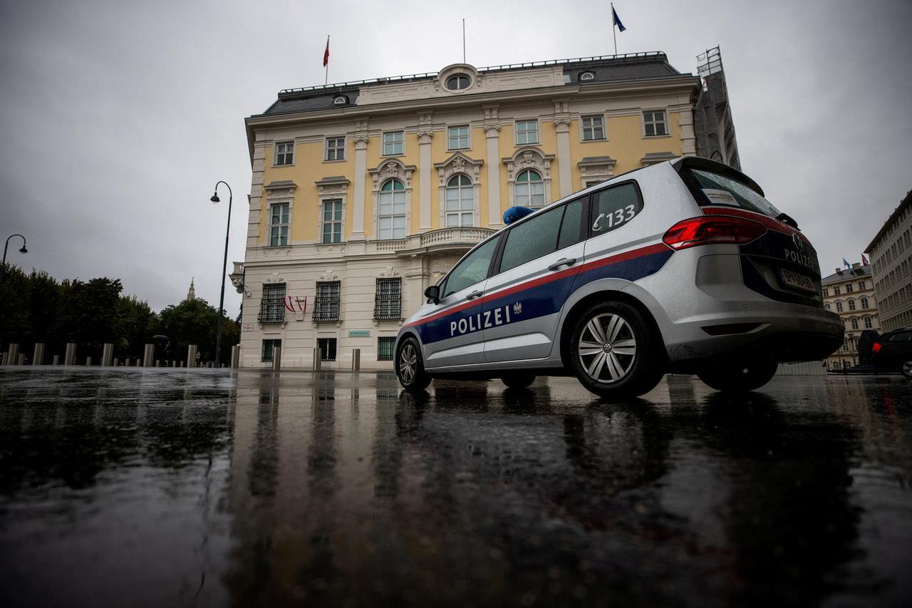 FILE PHOTO: Police car parks in front of the Austrian federal chancellery, in Vienna