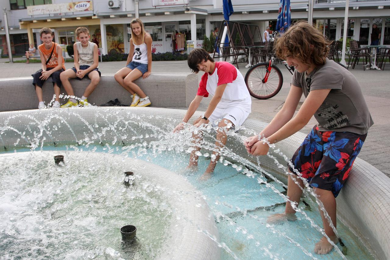 19.08.2011.,Velika Gorica - Ljetne vrucine su se vratile u grad. Temperature su presle preko 30 stupnjeva. Na glavnom gradskom trgu ljudi se rashladjuju uz fontanu. Photo: Goran Jakus/PIXSELL