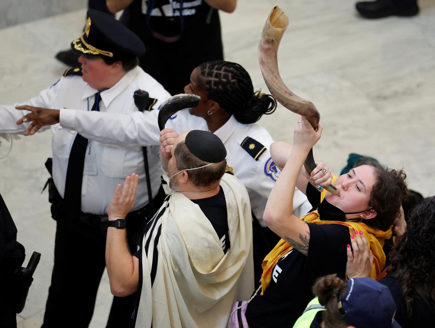 Protestors continue to blow on shofar horns as they are grabbed and detained by U.S. Capitol police officers during a civil disobedience action organized by a group called "Jewish Voice for Peace," calling for a cease fire in Gaza, while occupying the rotunda of the Cannon House office building on Capitol Hill in Washington, U.S., October 18, 2023. REUTERS/Jonathan Ernst Photo: JONATHAN ERNST/REUTERS