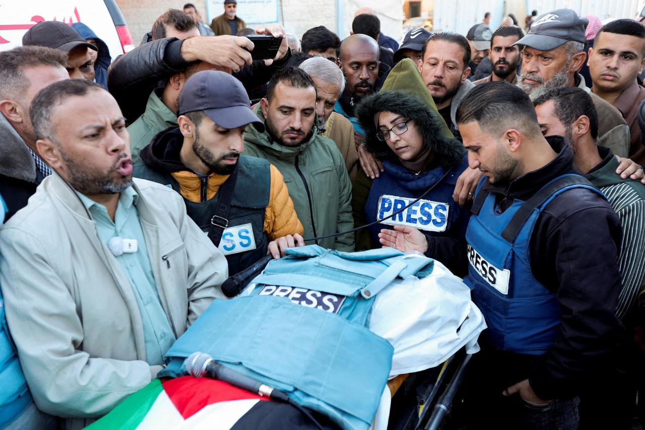 Mourners attend the funeral of Palestinian Ahmed Al-Louh, at Al-Aqsa Martyrs Hospital, in Deir Al-Balah, in the central Gaza Strip